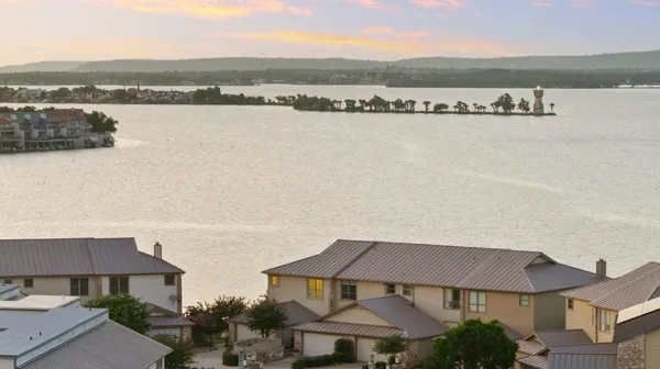 an aerial view of residential building with outdoor space and lake view