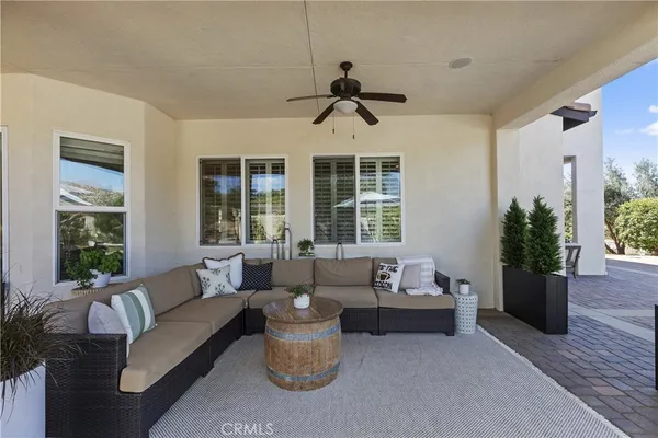 a living room with lots of furniture and a large window