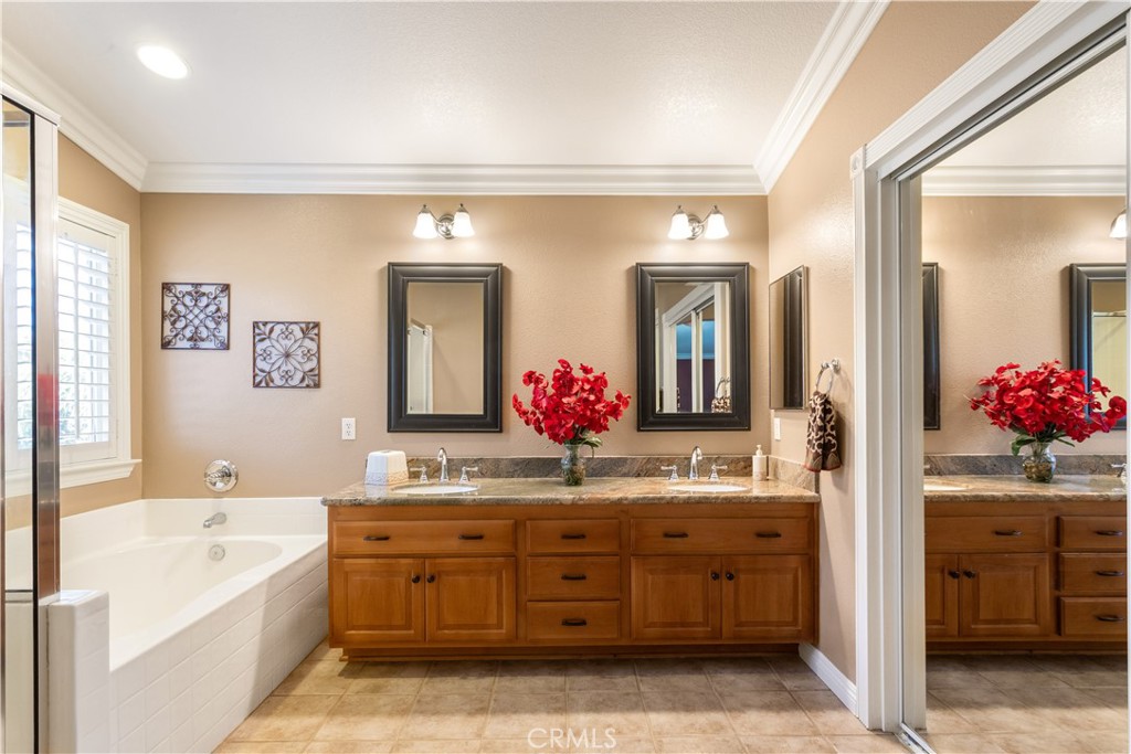 33351 Nicholas Common Temecula, CA 92592 - Photo 22 of 42 a spacious bathroom with a granite countertop tub sink and mirror