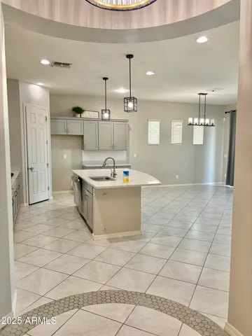 a view of a kitchen with a sink and a large window