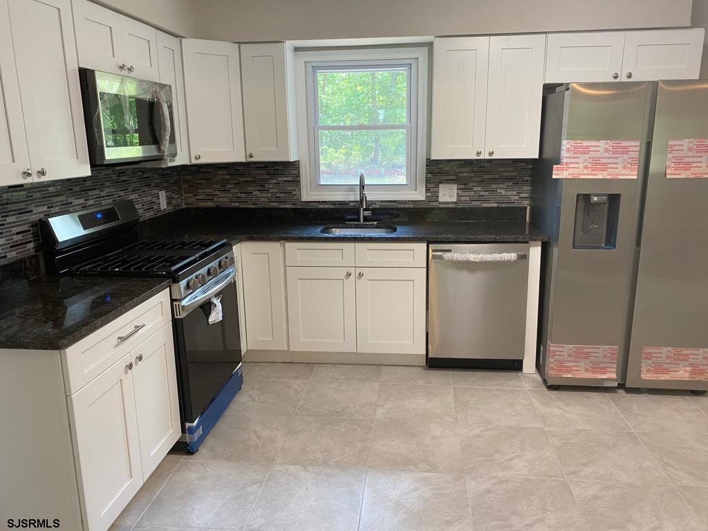 1564 Old Egg Harbor Road Mays Landing, NJ 08330 - Photo 3 of 11 a kitchen with granite countertop a sink and a stove