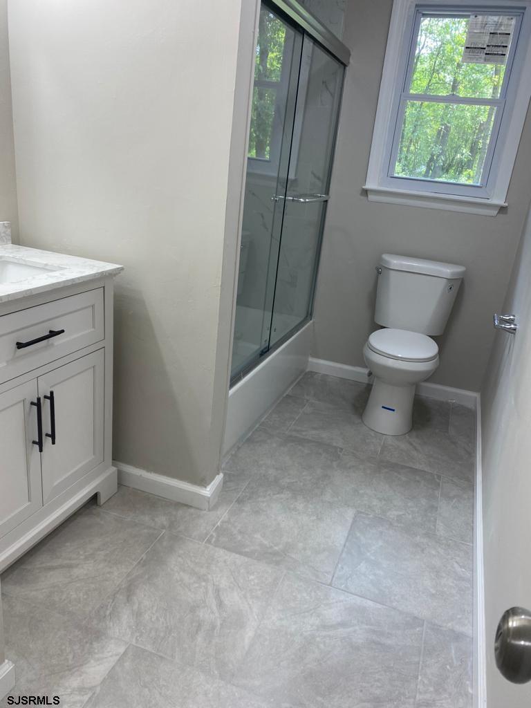 1564 Old Egg Harbor Road Mays Landing, NJ 08330 - Photo 4 of 11 a bathroom with a sink toilet and window
