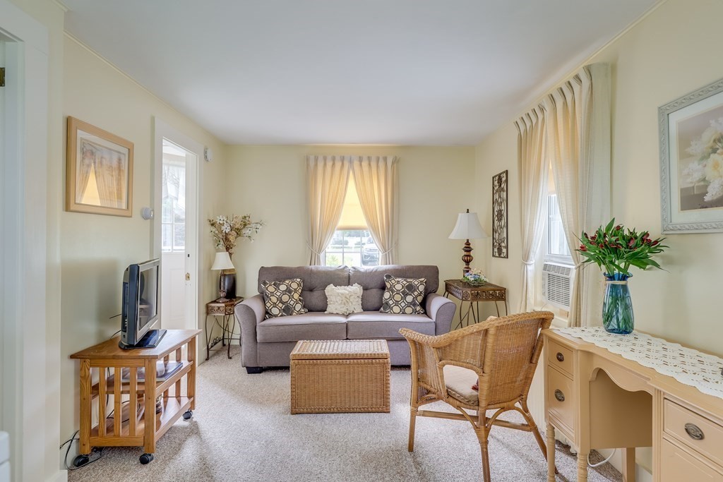 208 Osterville West Barnstable Road Barnstable, MA 02655 - Photo 17 of 27 a living room with furniture a fireplace and a window