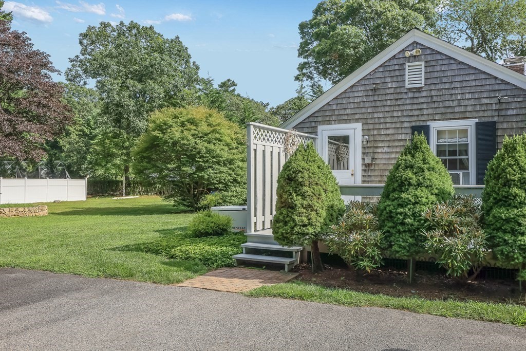 208 Osterville West Barnstable Road Barnstable, MA 02655 - Photo 22 of 27 a front view of a house with a yard