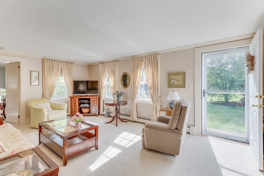 208 Osterville West Barnstable Road Barnstable, MA 02655 - Photo 4 of 27 a living room with furniture a large window and a flat screen tv