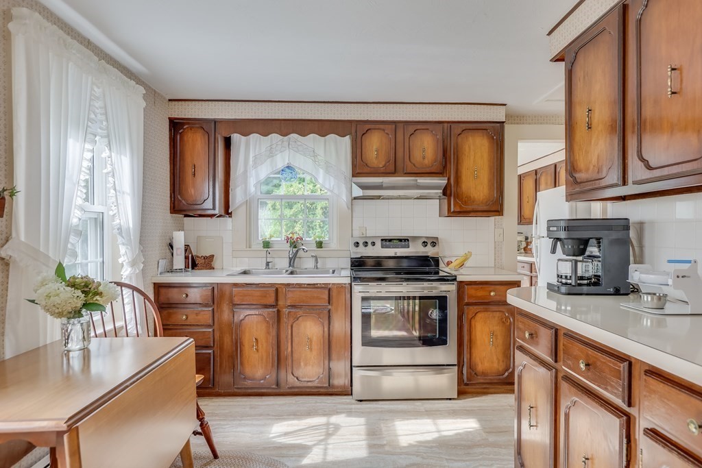 208 Osterville West Barnstable Road Barnstable, MA 02655 - Photo 8 of 27 a kitchen with stainless steel appliances granite countertop a stove a sink and a microwave