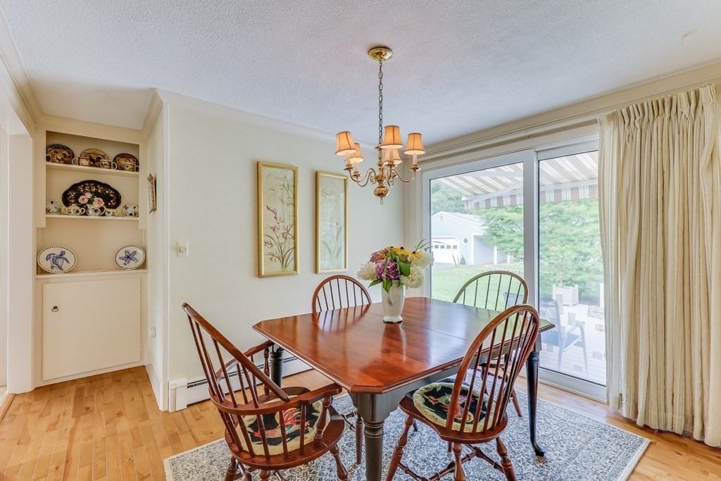 208 Osterville West Barnstable Road Barnstable, MA 02655 - Photo 10 of 27 a dining room with furniture a chandelier and wooden floor
