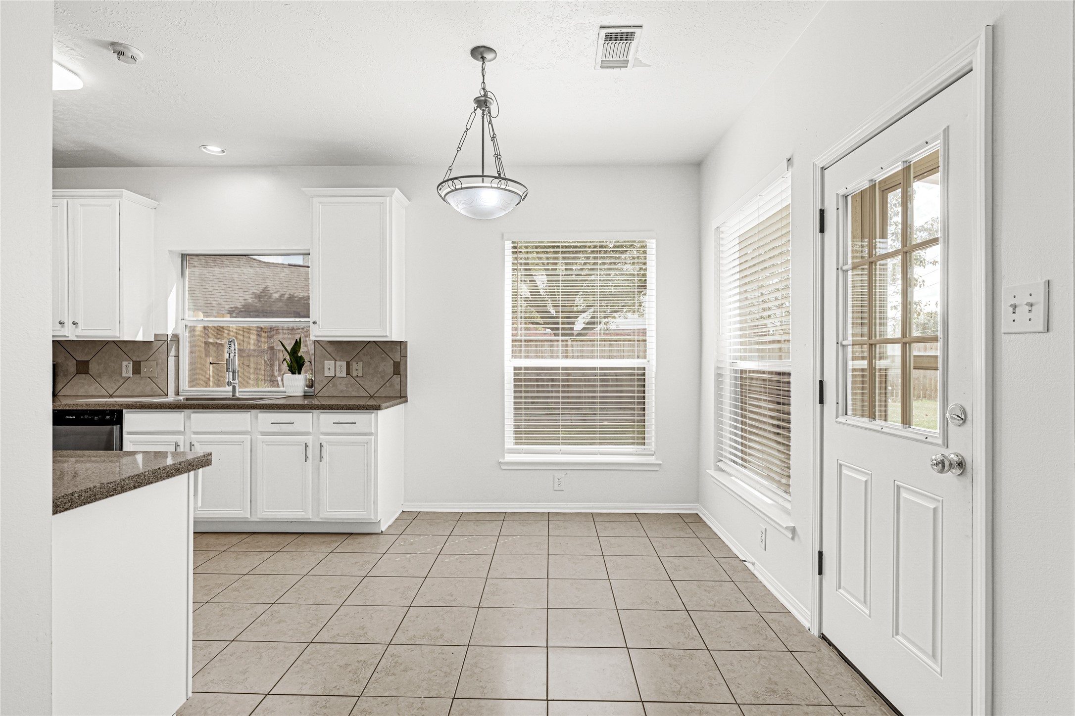4807 Elm View Circle Houston, TX 77084 - Photo 11 of 27 a kitchen with granite countertop a stove a sink and a refrigerator