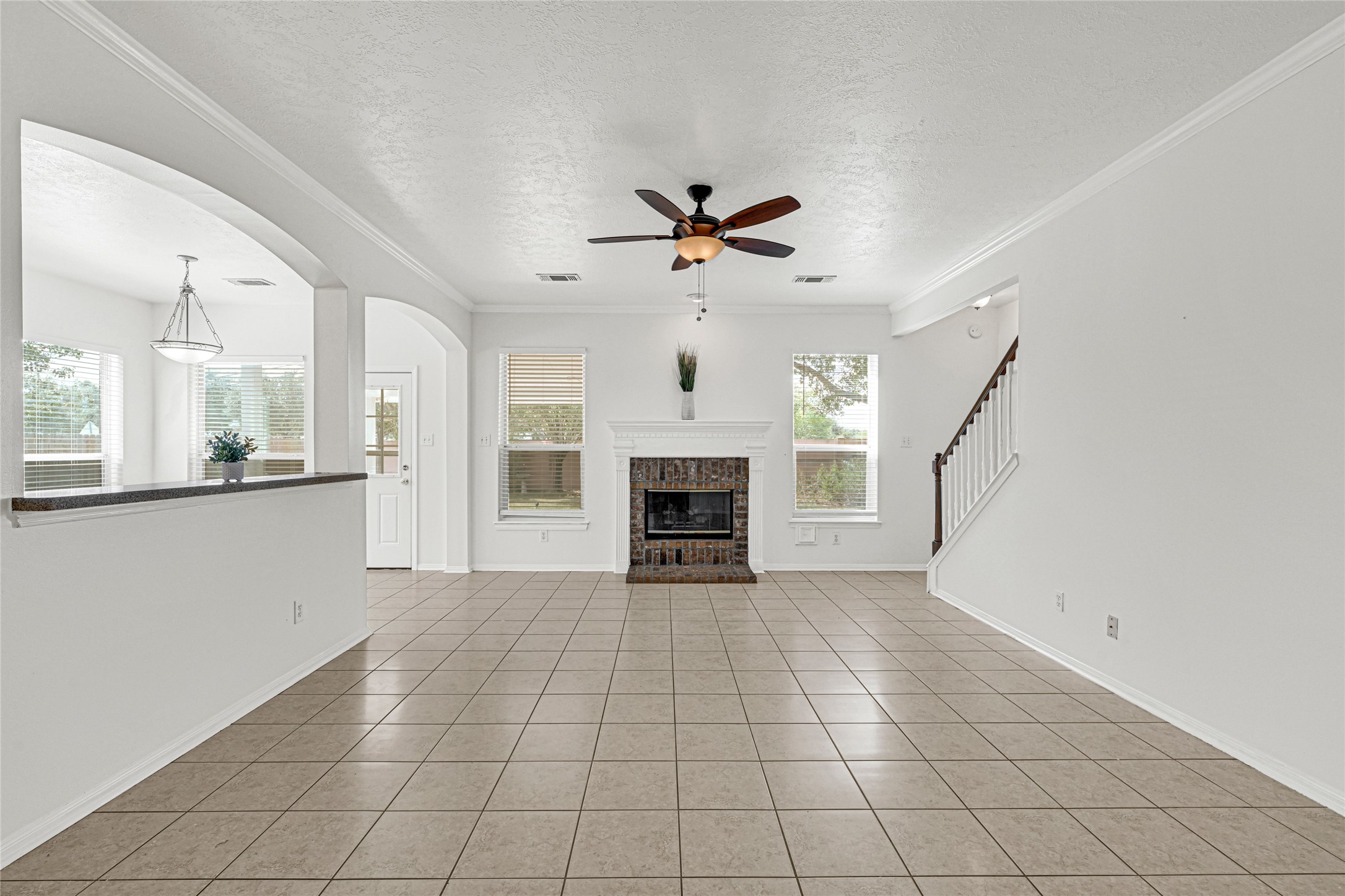 4807 Elm View Circle Houston, TX 77084 - Photo 8 of 27 a view of a livingroom with a fireplace a ceiling fan and windows