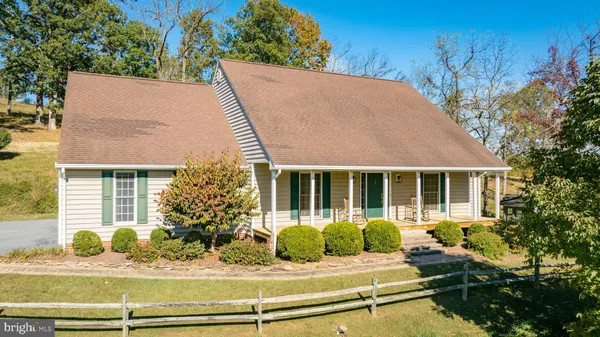 a front view of a house with a garden and plants