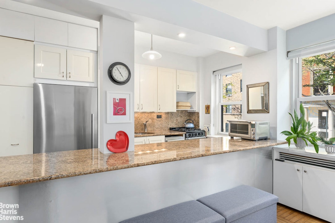 11 Riverside Drive, Unit 1DW Manhattan, NY 10023 - Photo 2 of 15 a kitchen with stainless steel appliances granite countertop a sink and a refrigerator