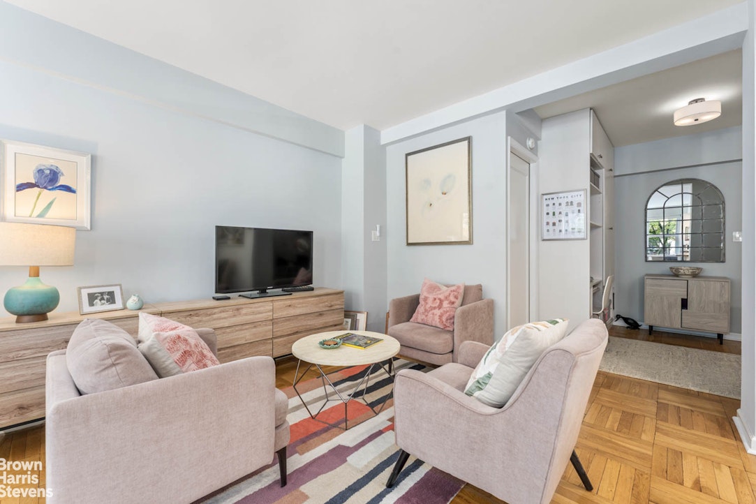 11 Riverside Drive, Unit 1DW Manhattan, NY 10023 - Photo 3 of 15 a living room with furniture and a flat screen tv