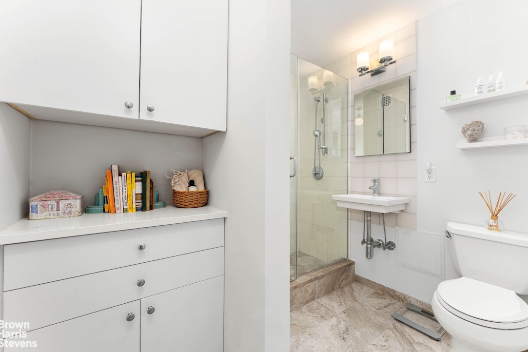 11 Riverside Drive, Unit 1DW Manhattan, NY 10023 - Photo 7 of 15 a bathroom with a sink a toilet and vanity