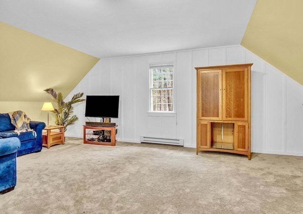 40 Bulkeley Road Littleton, MA 01460 - Photo 13 of 35 a living room with furniture and a flat screen tv