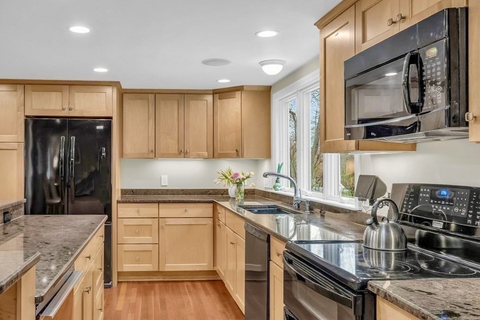 40 Bulkeley Road Littleton, MA 01460 - Photo 7 of 35 a kitchen with a sink a stove and cabinets