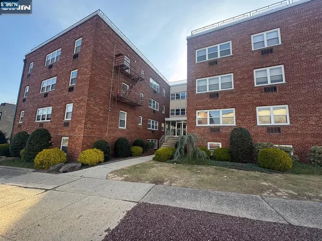 a view of a brick building next to a yard