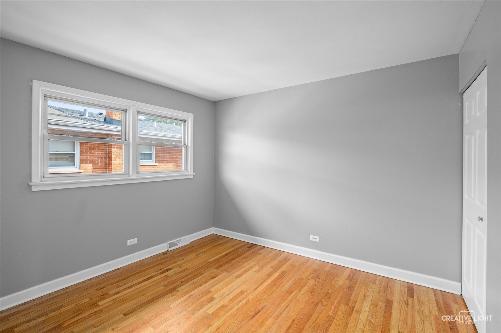 8802 Prospect Street Niles, IL 60714 - Photo 13 of 20 a view of a room with wooden floor and a window