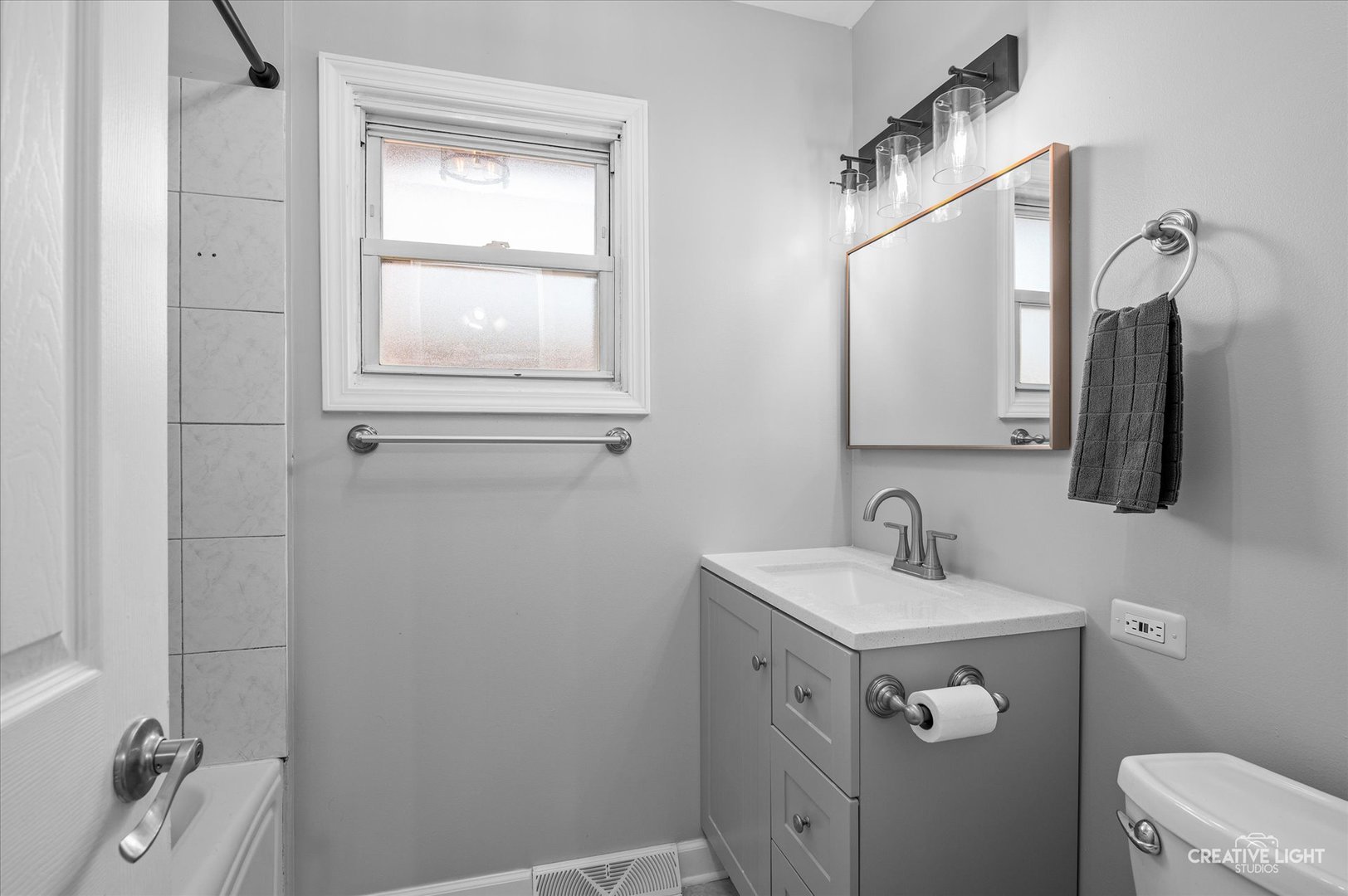 8802 Prospect Street Niles, IL 60714 - Photo 14 of 20 a bathroom with a sink and a mirror