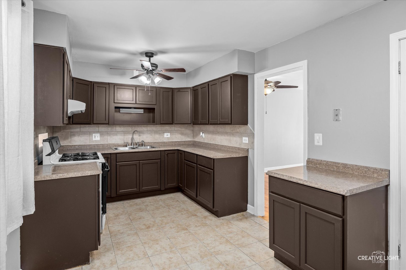 8802 Prospect Street Niles, IL 60714 - Photo 6 of 20 a kitchen with kitchen island granite countertop a sink cabinets and stainless steel appliances
