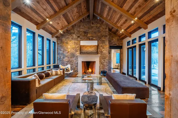 a living room with furniture a fireplace and a table