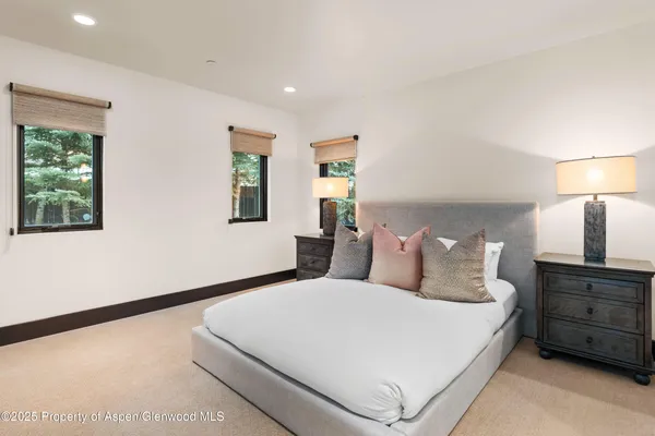 a bedroom with a bed and a night stand