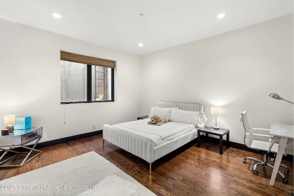 a bedroom with a bed and a desk