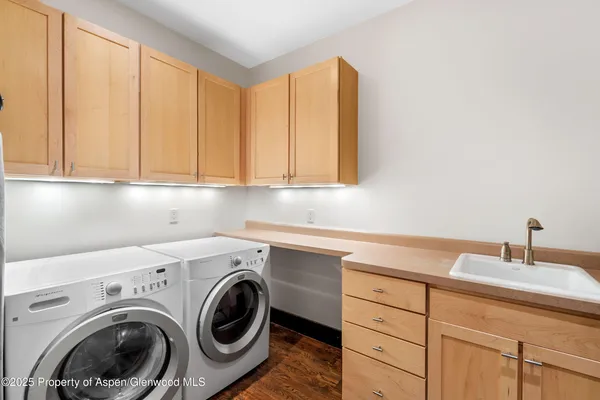 a utility room with sink dryer and washer