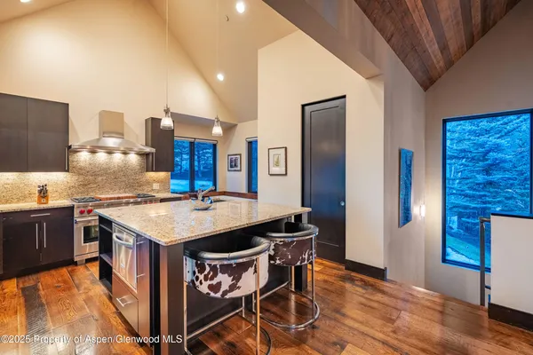 a kitchen that has a table and chairs in it