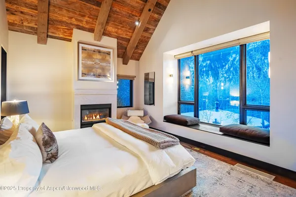 a bedroom with a bed couch and window