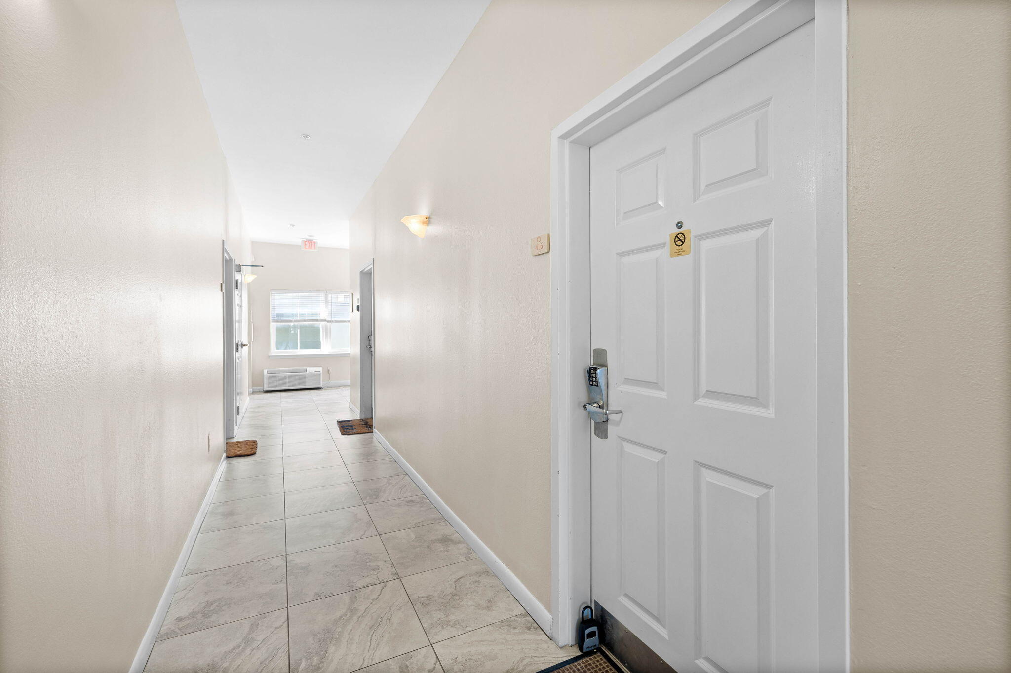 45 Town Center Loop, Unit 416 Santa Rosa Beach, FL 32459 - Photo 6 of 32 a view of a hallway with wooden floor and a bathroom