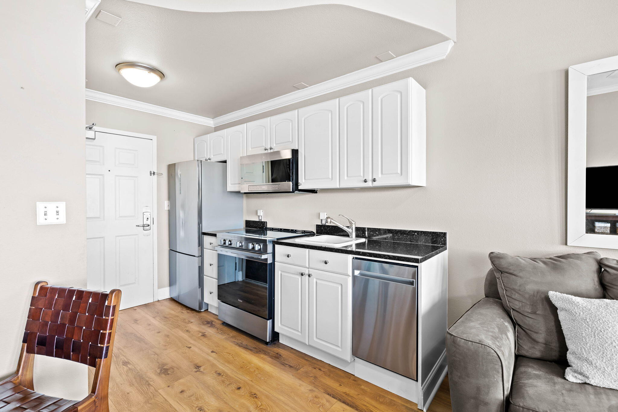 45 Town Center Loop, Unit 416 Santa Rosa Beach, FL 32459 - Photo 8 of 32 a kitchen with stainless steel appliances granite countertop a stove top oven a sink dishwasher and white cabinets