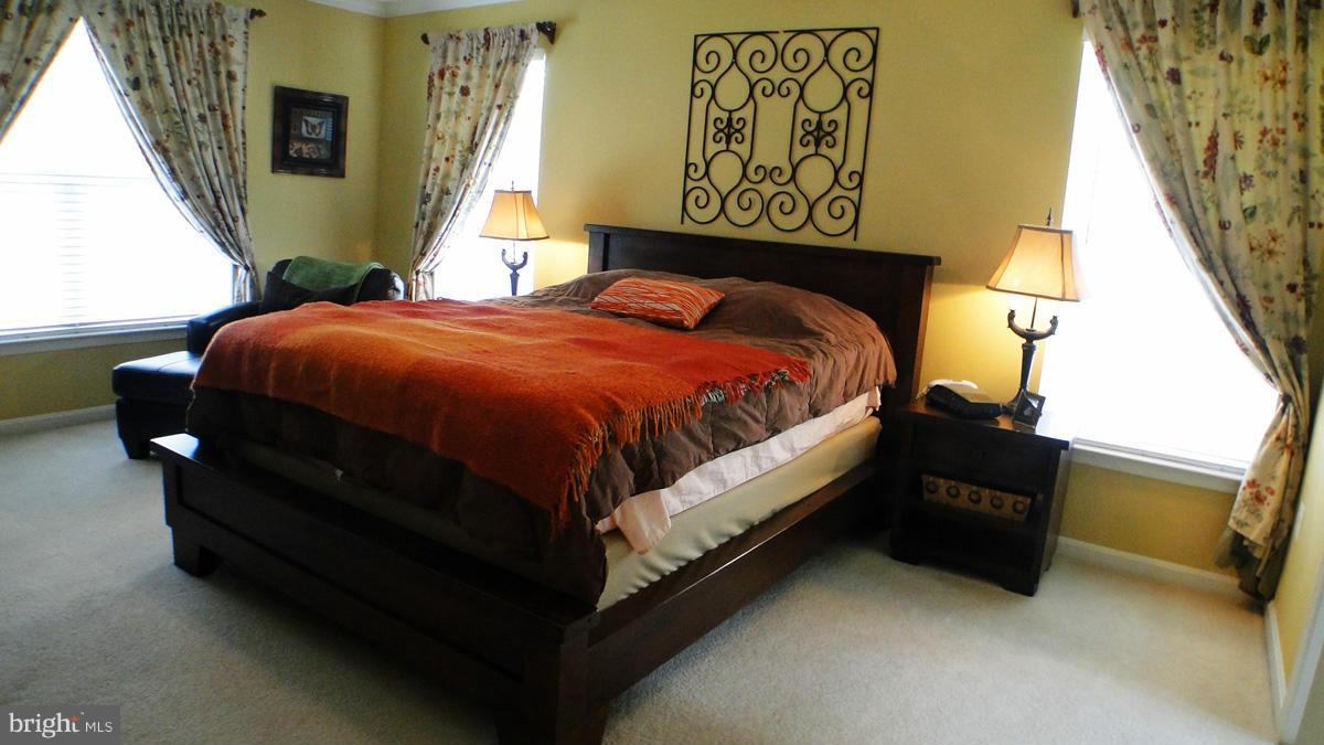 7671 Swallow Road Sykesville, MD 21784 - Photo 12 of 30 a bed sitting in a bedroom next to a window