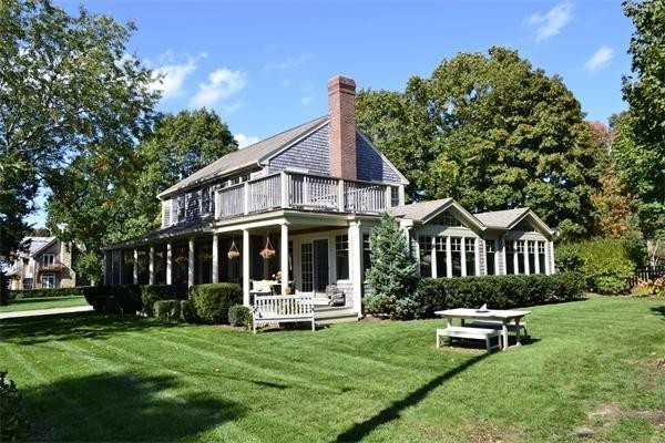 a front view of a house with a yard table and chairs