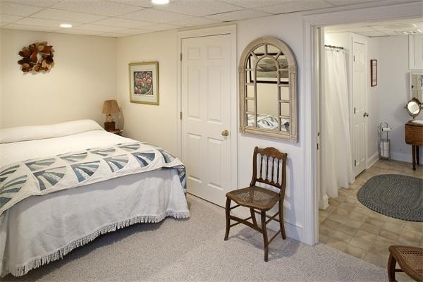 38 Standish Road Duxbury, MA 02332 - Photo 19 of 21 a bedroom with a bed and a chair