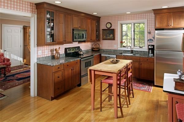 38 Standish Road Duxbury, MA 02332 - Photo 4 of 21 a kitchen with stainless steel appliances granite countertop a stove a sink a microwave refrigerator and chairs