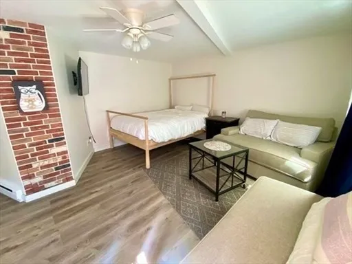 a bedroom with furniture and a wooden floor