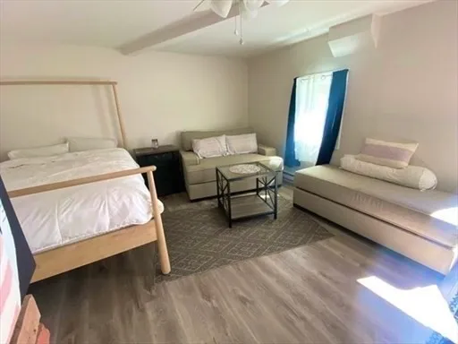a bedroom with a bed and a mirror