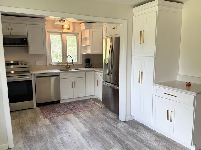 a kitchen with a refrigerator a sink and a stove