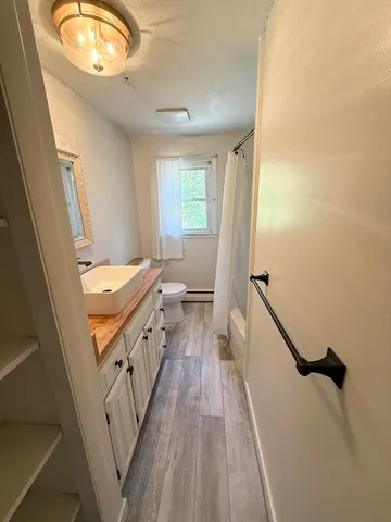 a bathroom with a sink a mirror and a toilet