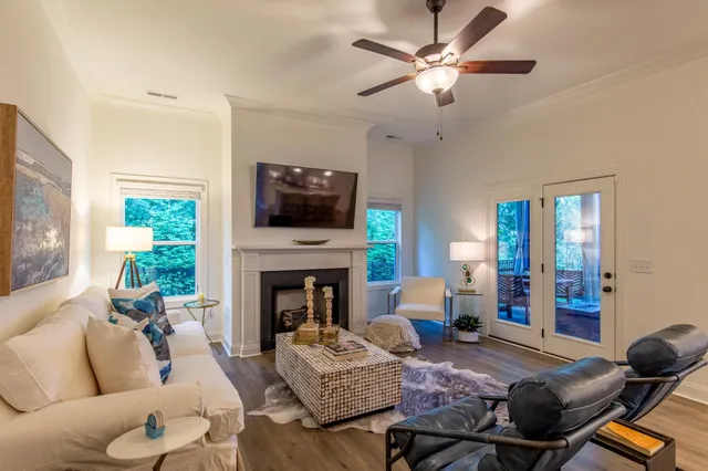 a living room with furniture a fireplace and a flat screen tv