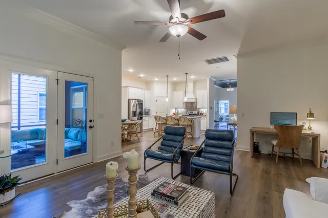 a living room with furniture and wooden floor