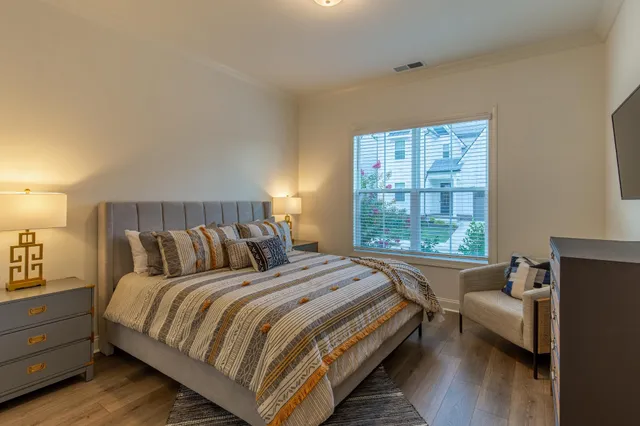 a bedroom with a bed and wooden floor