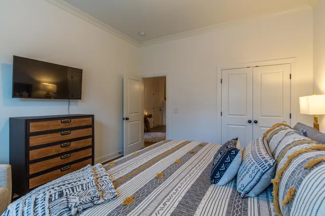 a bedroom with a bed and a flat screen tv