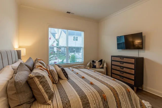 a bedroom with a bed and a flat screen tv