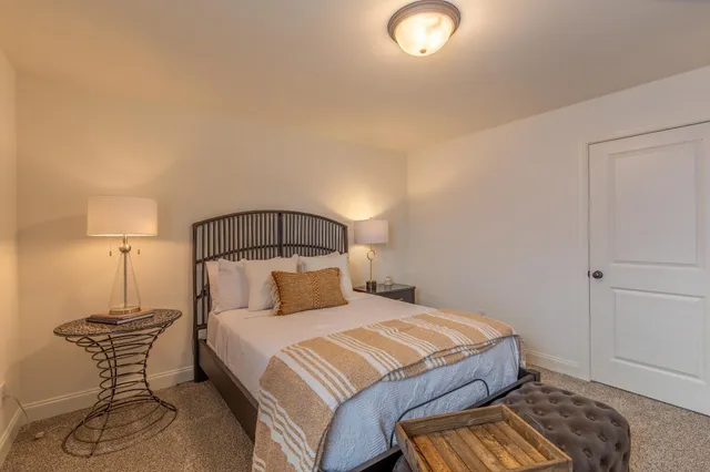 a bedroom with a bed and a lamp