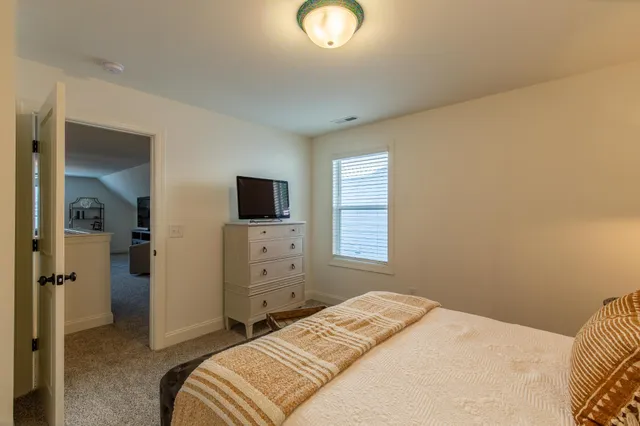 a bedroom with a bed and flat screen tv
