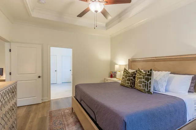 a bedroom with a bed and a ceiling fan