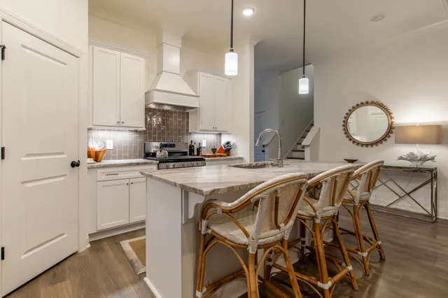 a kitchen with a table a sink and cabinets