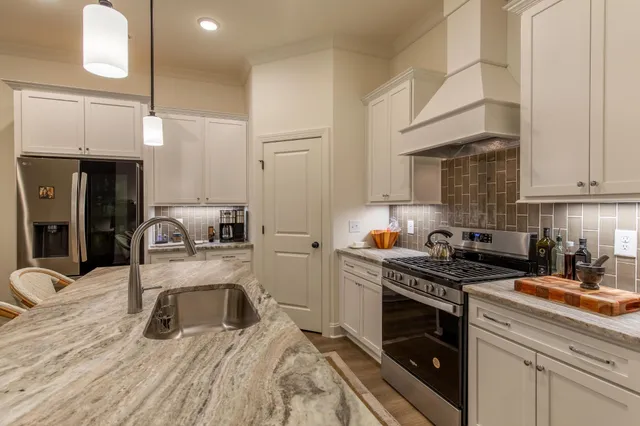 a kitchen with a sink stove and cabinets