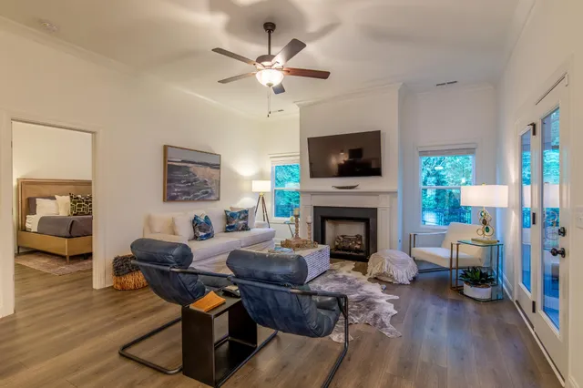 a living room with furniture a fireplace and a flat screen tv